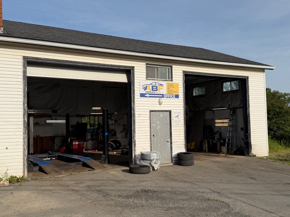 ABF Complete Auto shop exterior with two open service bays and ABF signage in Lower Sackville